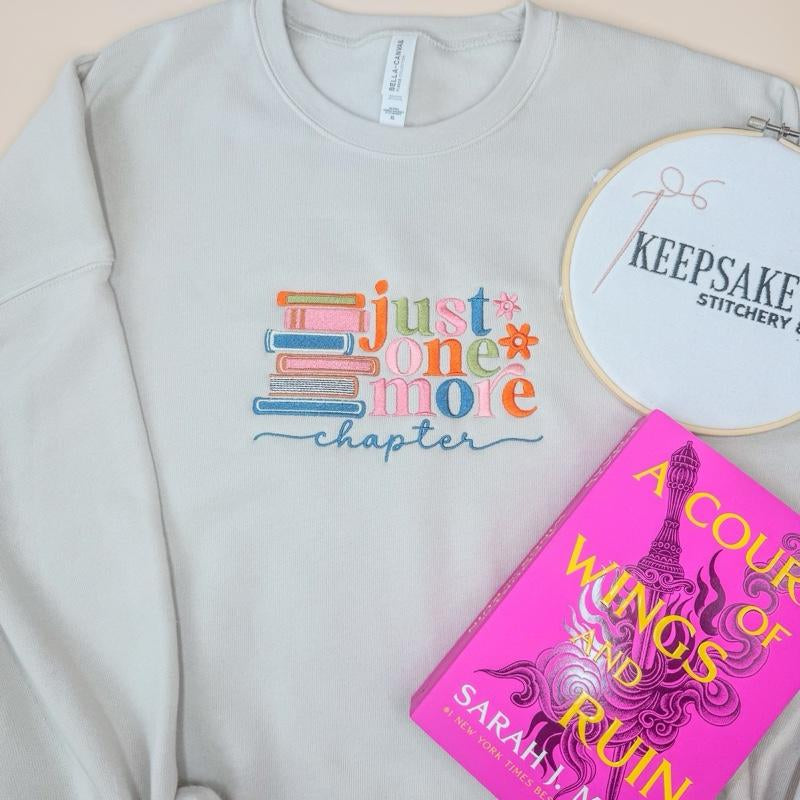 Just One More Chapter Sweater - White Pullover with Colorful Book Design and "Chapter" Text - Womenswear