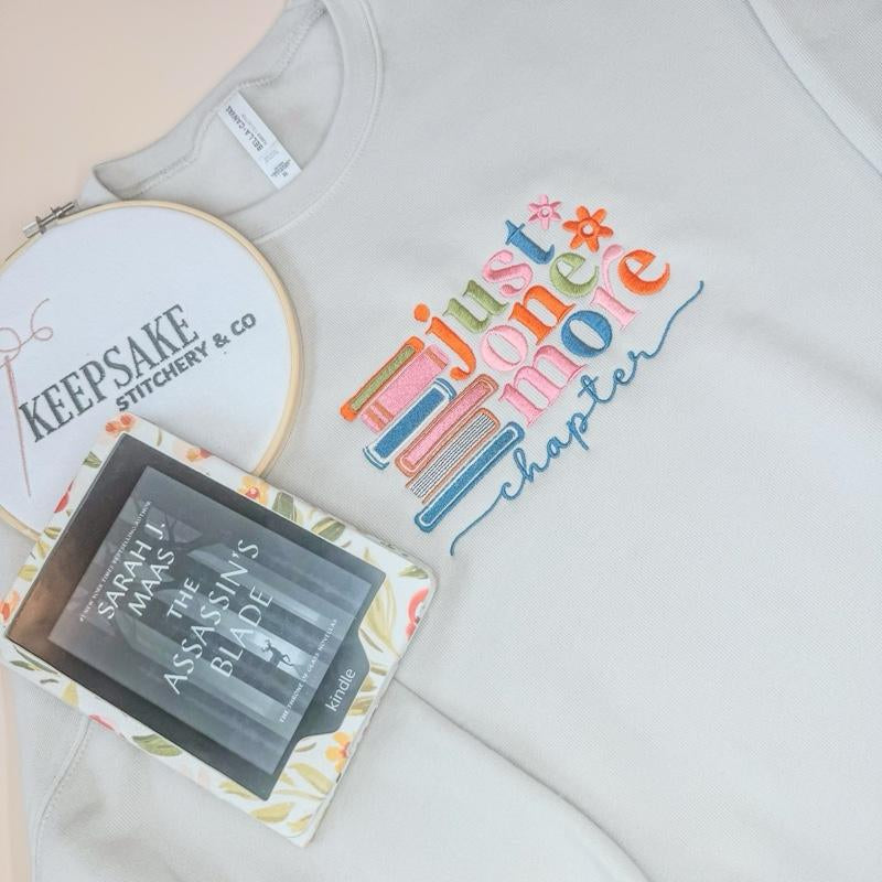 Just One More Chapter Sweater - White Pullover with Colorful Book Design and "Chapter" Text - Womenswear