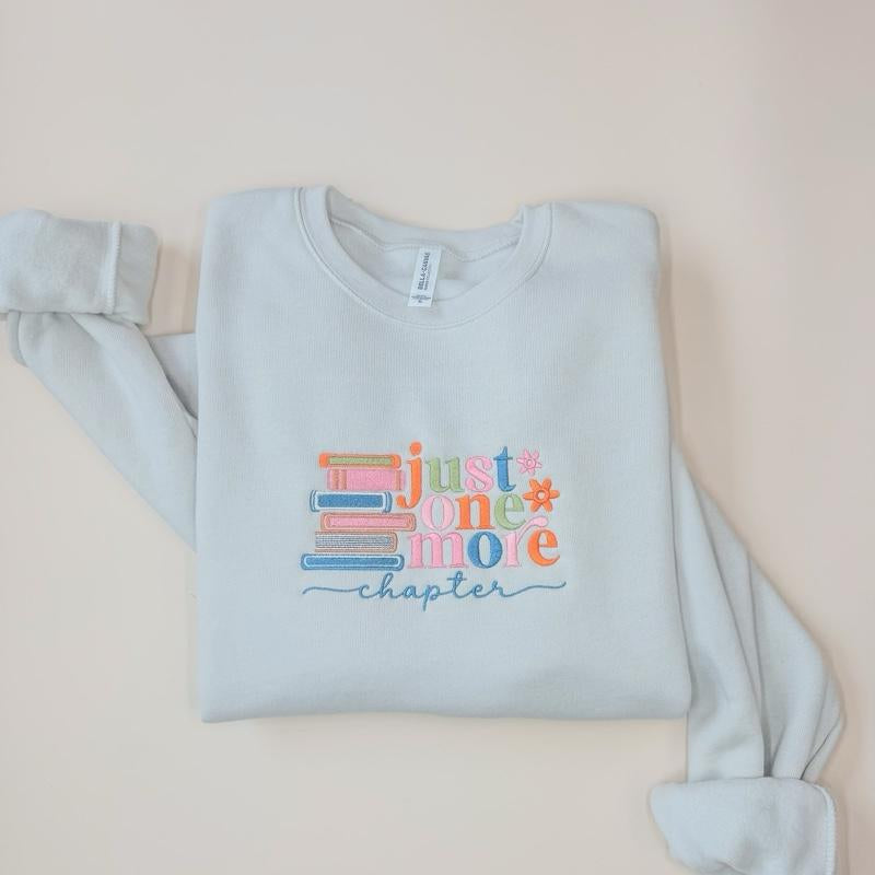 Just One More Chapter Sweater - White Pullover with Colorful Book Design and "Chapter" Text - Womenswear