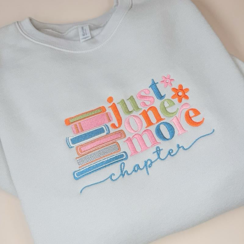 Just One More Chapter Sweater - White Pullover with Colorful Book Design and "Chapter" Text - Womenswear